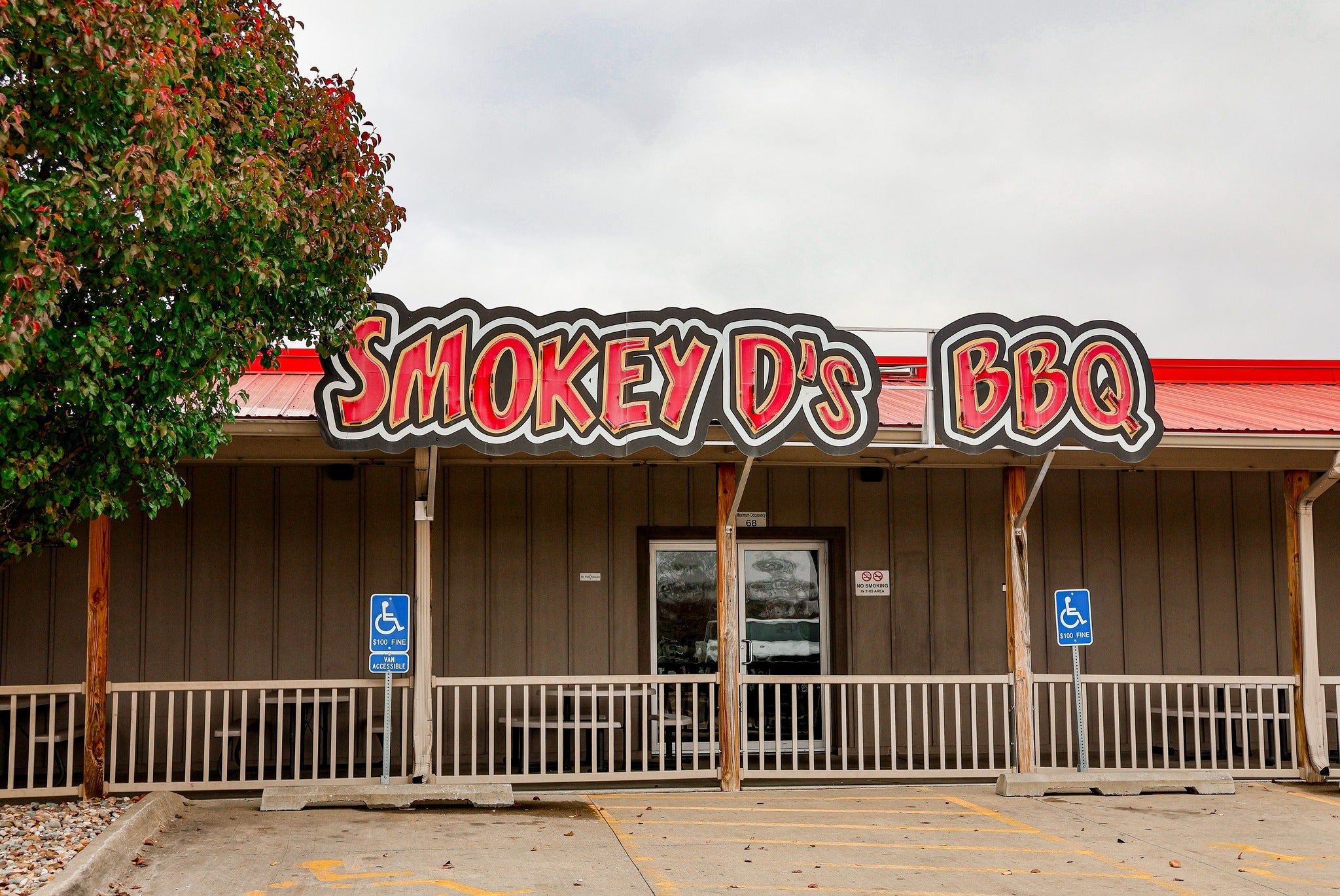Exterior view of Smokey D’s BBQ, one of the best restaurants in Des Moines IA, featuring the recognizable red and black sign above the main entrance.